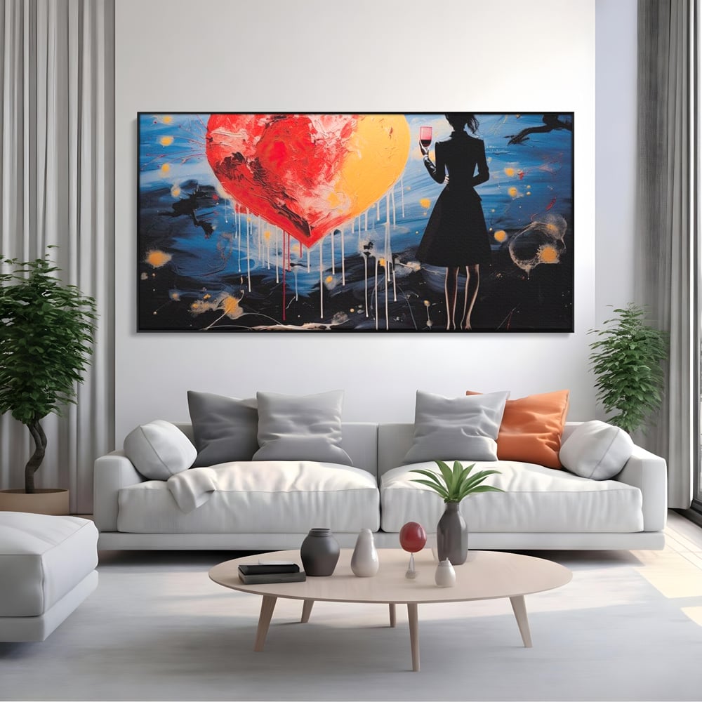 Tablou canvas cu tablou canvas cu femeie si inima uriasa, in rama de aluminiu negru, pe perete intr-un living
